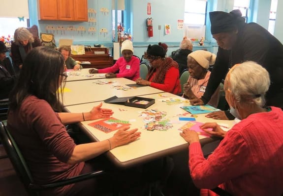 Residents participating in a crafting activity at a table