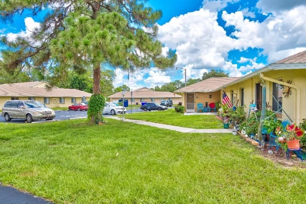 Exterior view of a senior living facility with garden