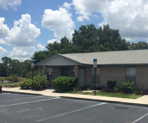 Exterior view of a single-story building with accessible parking