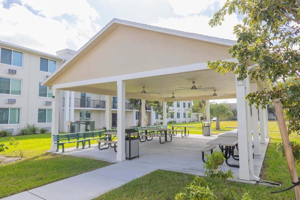 Covered outdoor space with seating and picnic tables
