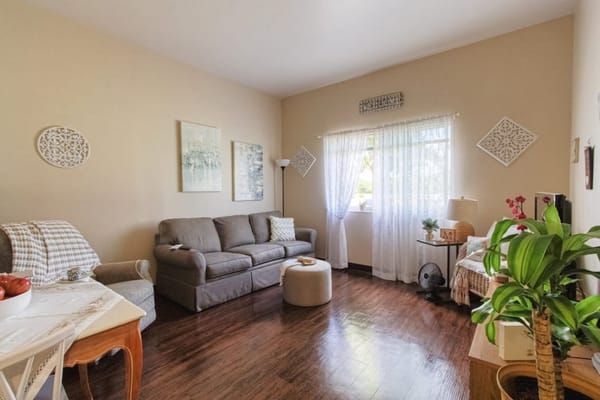 A cozy living room with a sofa, table, and window