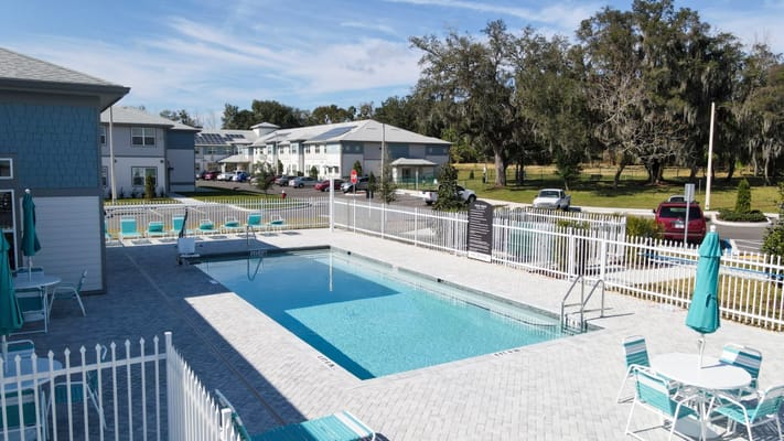 Aerial view of a pool area with adjacent buildings