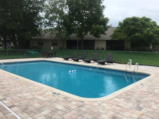 Outdoor pool area with lounge chairs