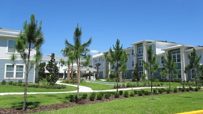 View of landscaped outdoor space with pathways and buildings