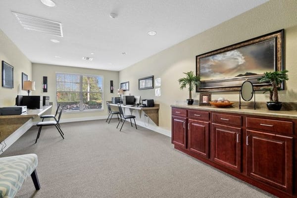 Well-lit business center with computers and seating