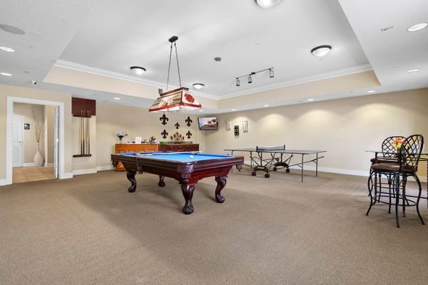 Interior of the recreation room with a pool table and seating area.