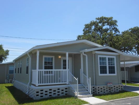 Exterior view of a Twin Lakes home with a porch and green lawn.