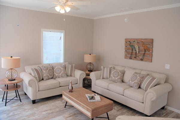 Welcoming living room with beige sofas and decorative pillows