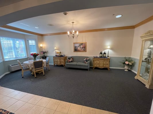 Common area with seating and decor in a senior living facility