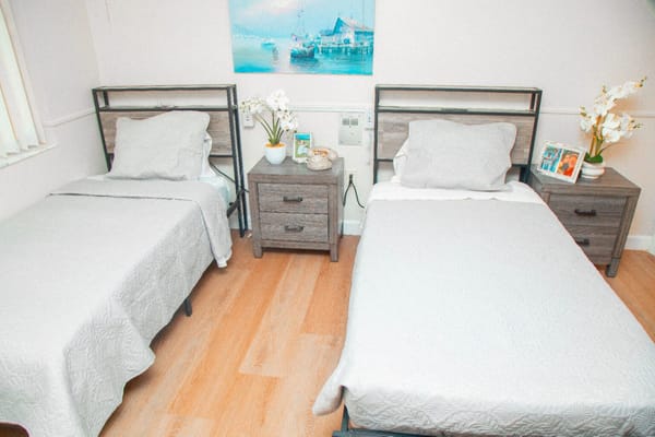 A well-furnished shared resident room with beds and decor