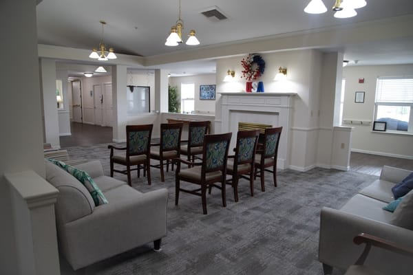 Common area with seating and fireplace in the facility