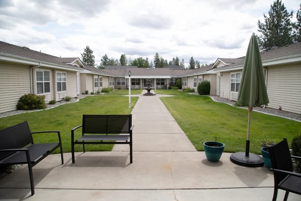 Well-maintained courtyard with seating at a senior living facility