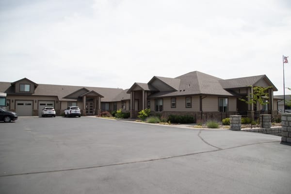 Exterior view of Providence Senior Home with parking area