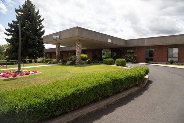 Front entrance of Riverview Retirement Community with landscaped garden