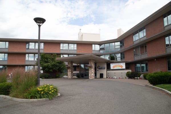 Entrance of Riverview Retirement Community with flowers and signage