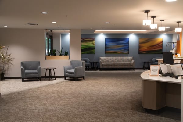 Cozy lounge area with seating and artwork