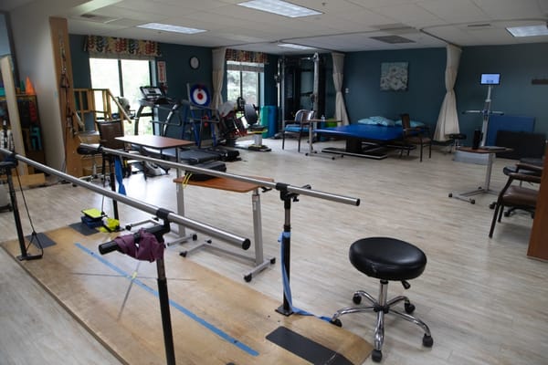 Interior view of the therapy room with equipment and therapy bars.