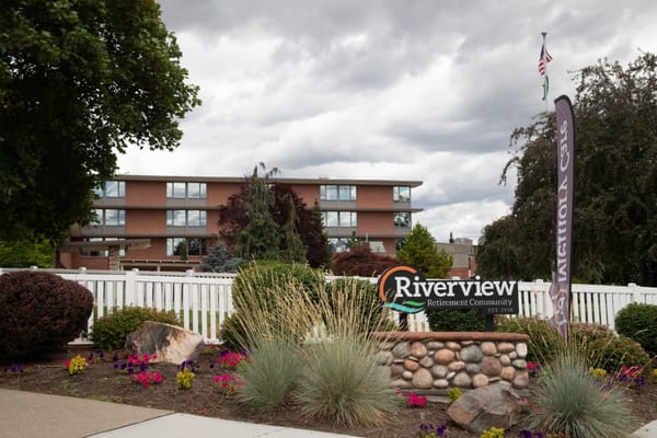 Entrance to Riverview Retirement Community with signage and landscaped garden