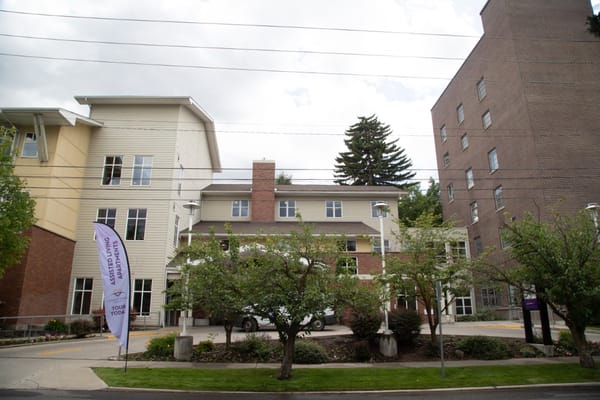Exterior view of a senior living facility with landscaping