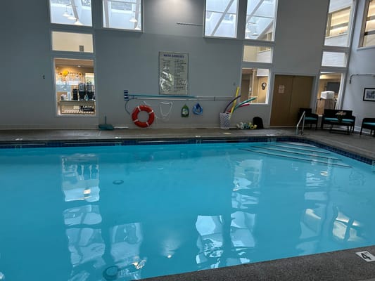 Indoor pool area with exercise equipment