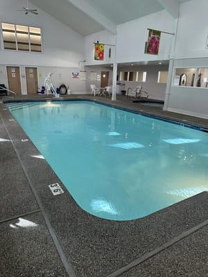 Indoor swimming pool with clear water and bright lighting