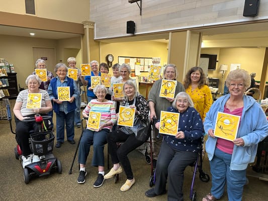 Residents showcasing their artwork in a common area