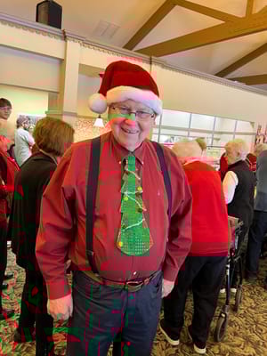 Resident celebrating in festive attire at a holiday event