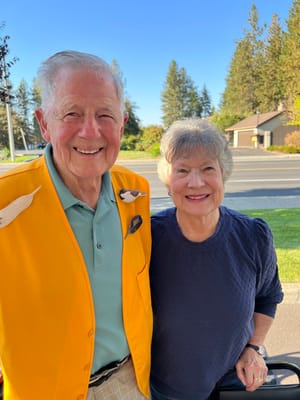 Two smiling residents outdoors in the community