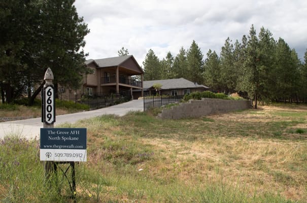 Front view of The Grove AFH North Spokane with sign at entrance