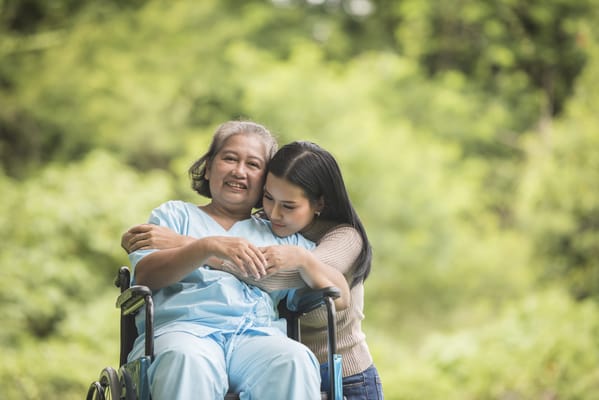 A caregiver and resident enjoying time outdoors together