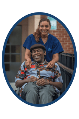 Staff member assisting a resident in a wheelchair