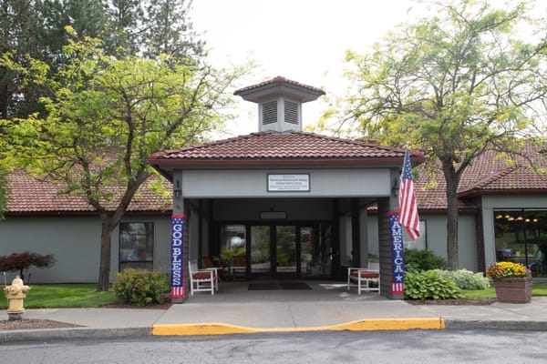 Entrance of Fairwood Retirement Village with flags and trees