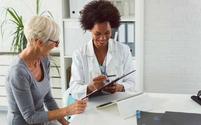 A medical professional discussing with a senior resident