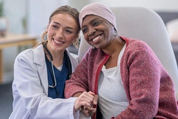 Healthcare worker and resident smiling together