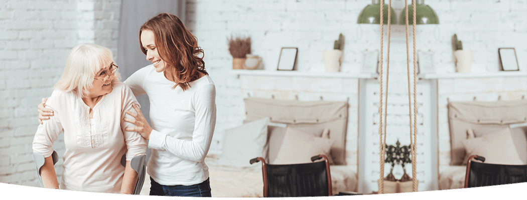 Caregiver assisting a resident in a cozy room