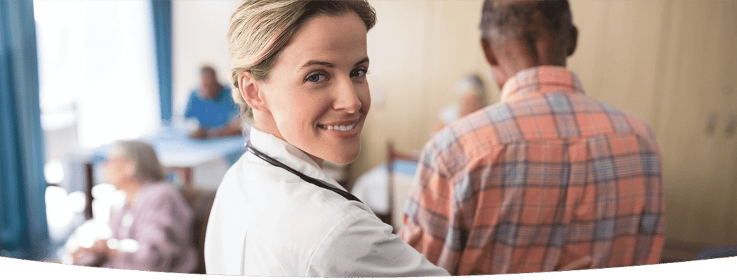 Healthcare professional assisting a senior in a communal setting