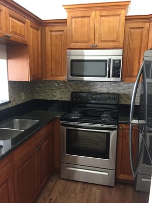 Modern kitchen with wooden cabinets and stainless appliances