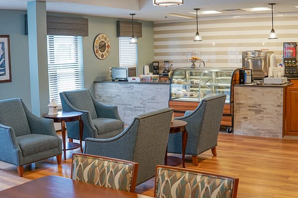 Cozy common area with seating and a dessert display