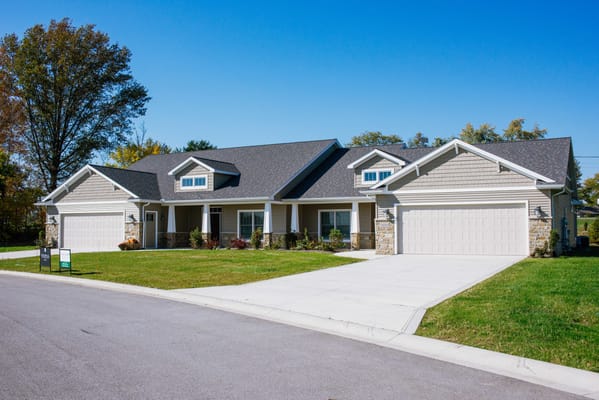 Exterior view of a senior living facility with garage