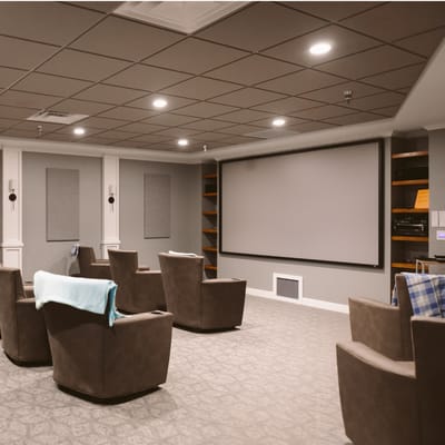 A cozy recreation room with seating and a large screen