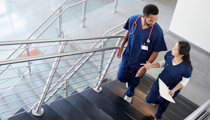 Healthcare staff collaborating on stairs in a modern interior