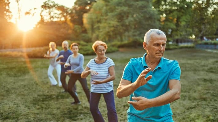 Residents participating in a tai chi class in the garden