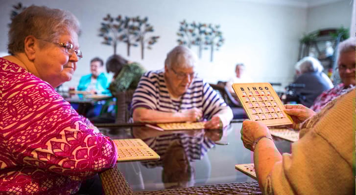 Residents engaging in a bingo game in a common area