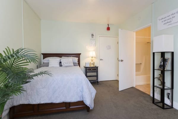 A cozy private resident room with a bed and decor