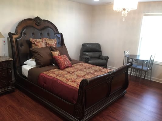 Cozy resident room with a large bed and seating area