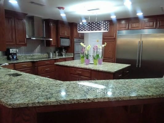 Modern kitchen with granite countertops and flowers