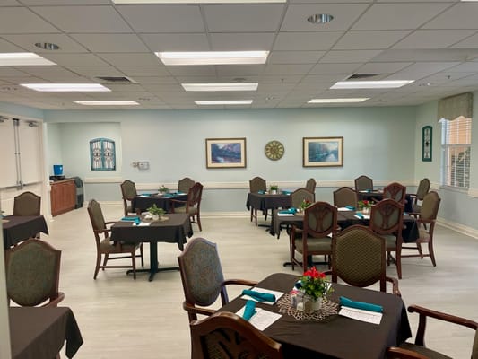 Dining area with tables set for meals in assisted living facility