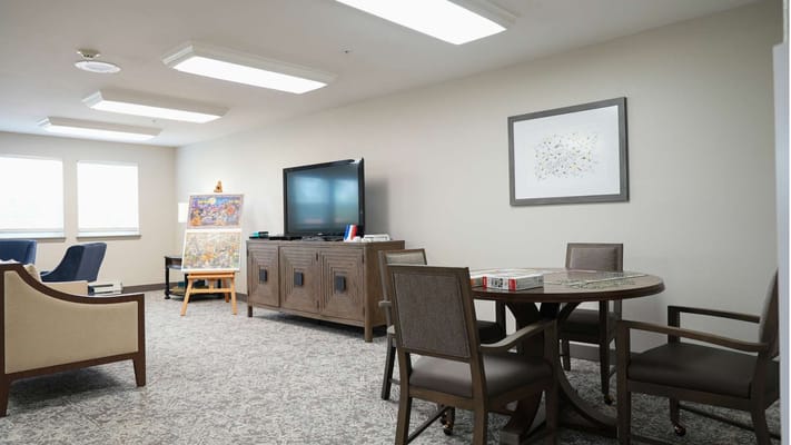 Interior common area with seating and a TV