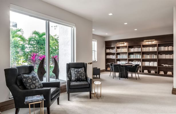Bright common area with seating and view of greenery