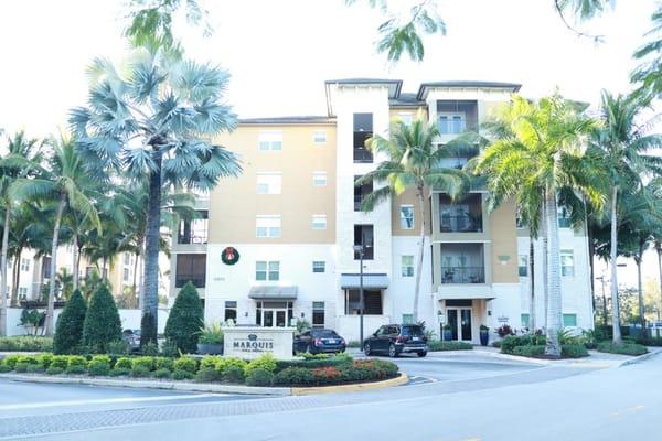 Exterior view of Marquis Coral Springs with palm trees